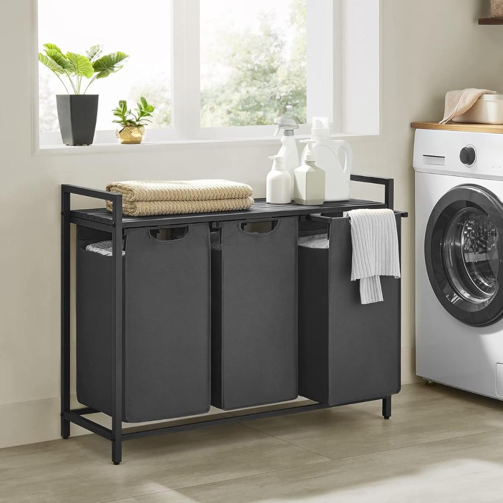 Black 3-compartment laundry hamper with a built-in shelf, designed for efficient laundry sorting and additional storage in any home.
