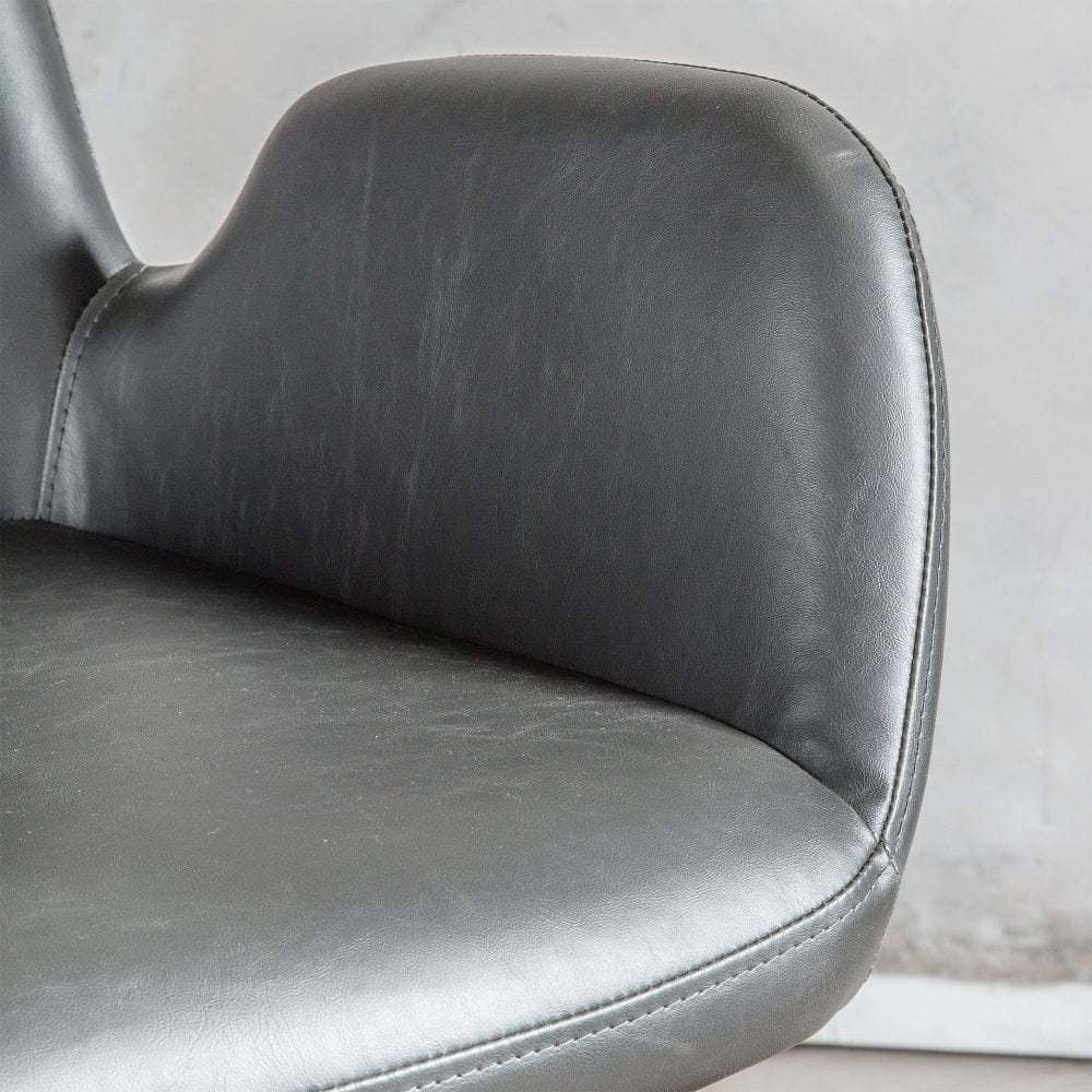 Contemporary swivel office chair in charcoal faux leather, featuring a supportive design with armrests for all-day comfort.
