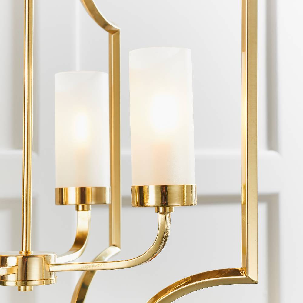 Elegantly designed chandelier with a brass frame and frosted glass shades, perfect for adding a refined and luxurious feel to any room.
