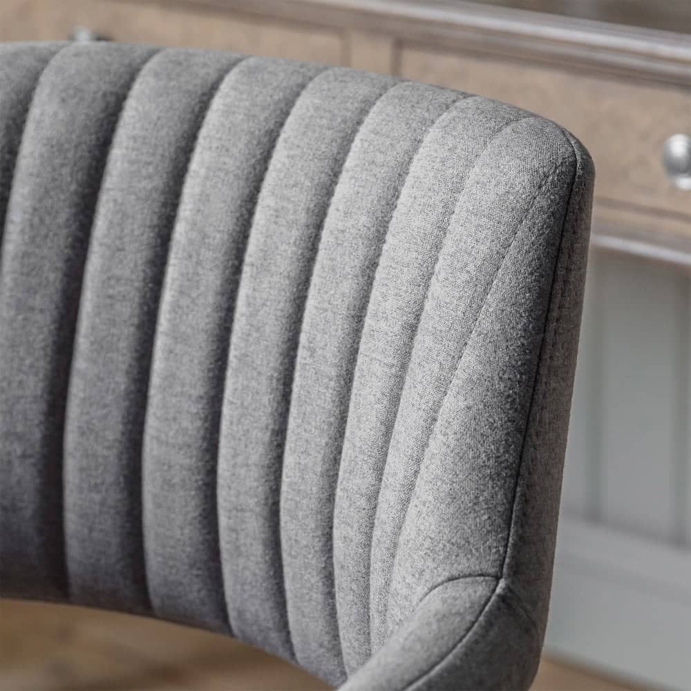 Sleek and practical upholstered office chair in grey, offering smooth 360-degree swivel, height adjustment from 445mm to 545mm, and five castors for easy mobility.
