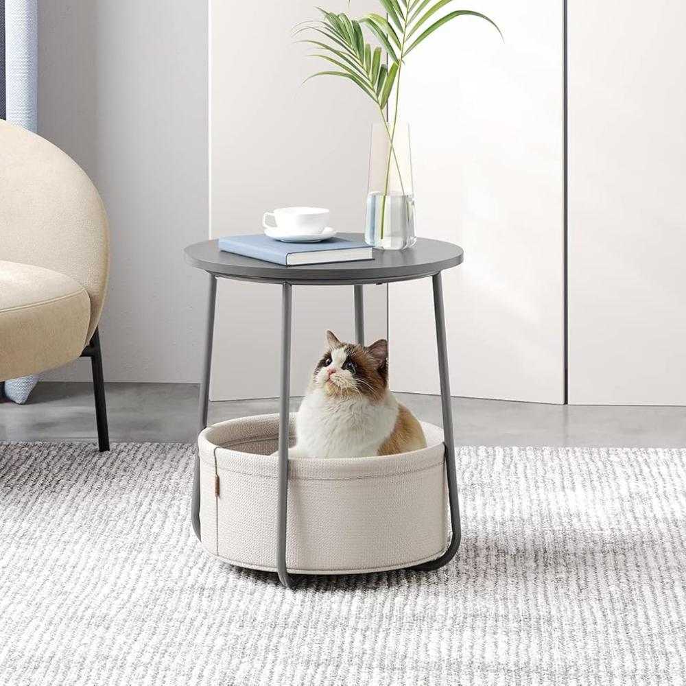 Round grey wooden side table with a built-in storage basket, combining modern design with practical organisation for living spaces.
