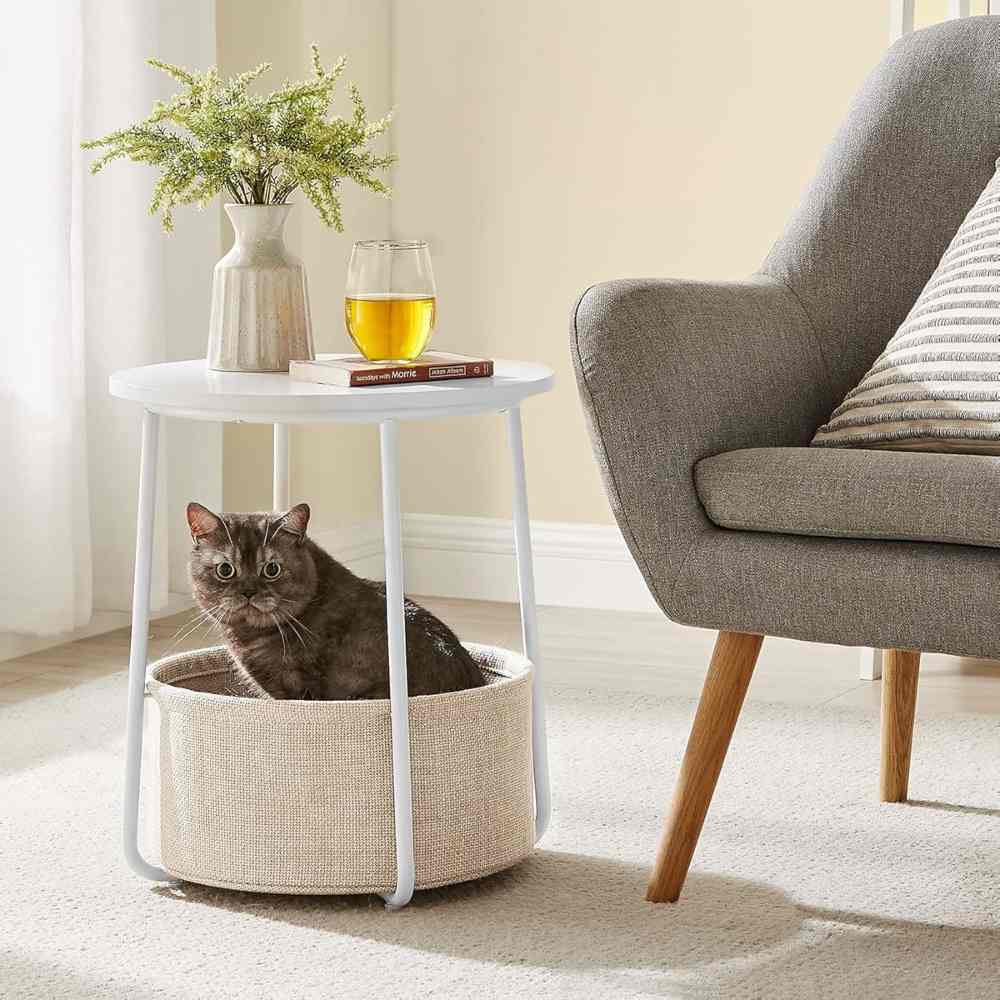 Round white wooden side table with a built-in storage basket, offering a stylish and practical solution for living rooms, bedrooms, or small spaces.
