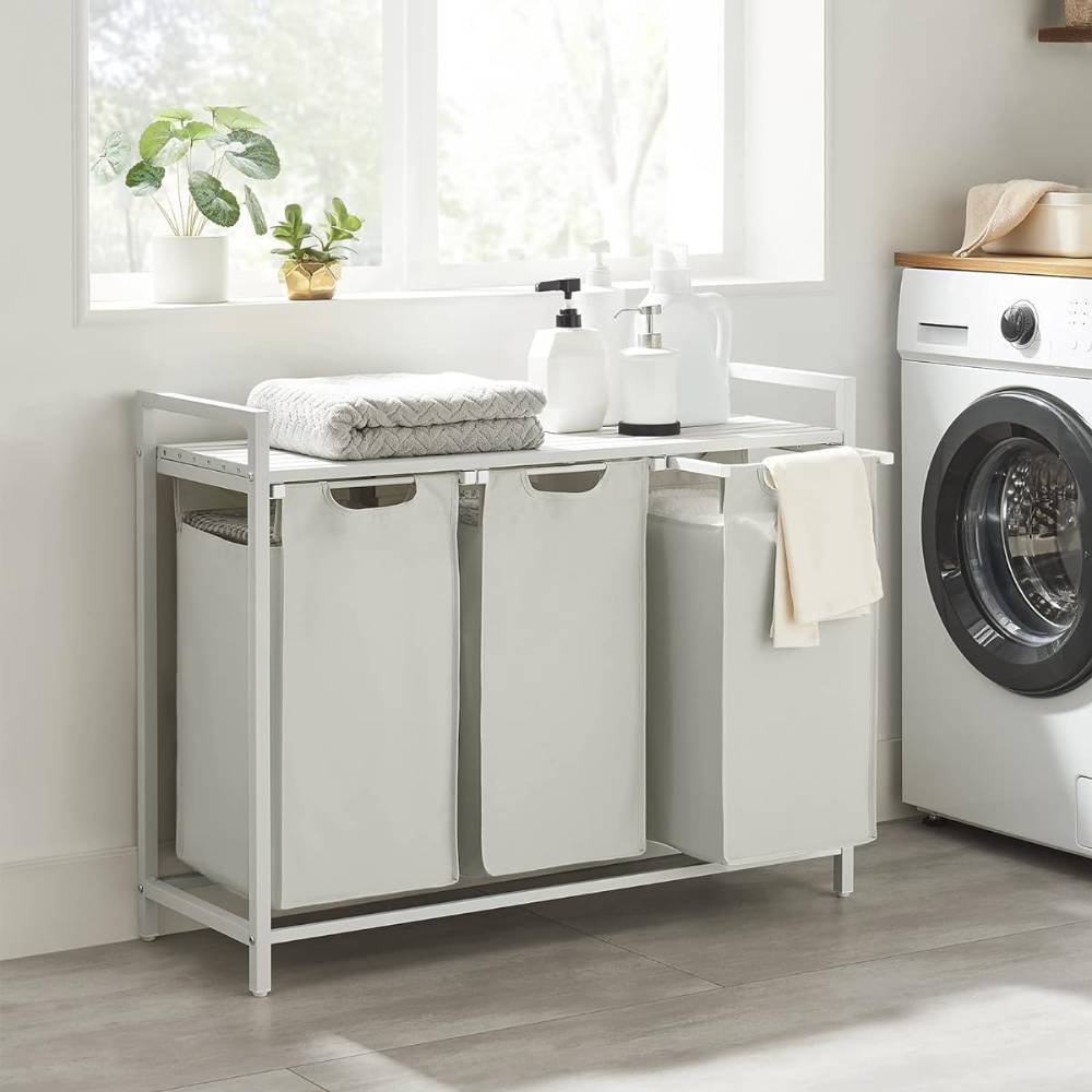 White 3-compartment laundry hamper with a built-in shelf, offering a stylish and practical solution for sorting and organising laundry.
